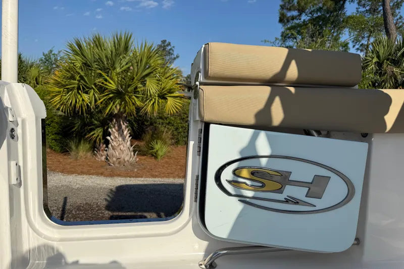 Slide: The Image of 2017 Sea Hunt Gamefish 25 boat interior with logo, palm trees in background. - 42