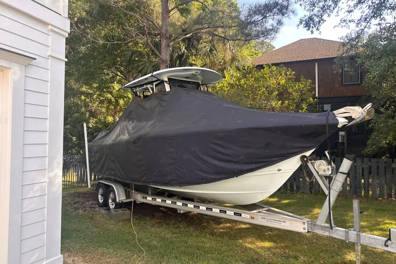 Slide: The Image of 2017 Sea Hunt Gamefish 25 boat covered on trailer in residential yard. - 44