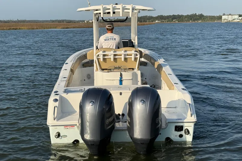 Slide: The Image of 2017 Sea Hunt Gamefish 25 boat with dual Yamaha engines on calm water. - 5