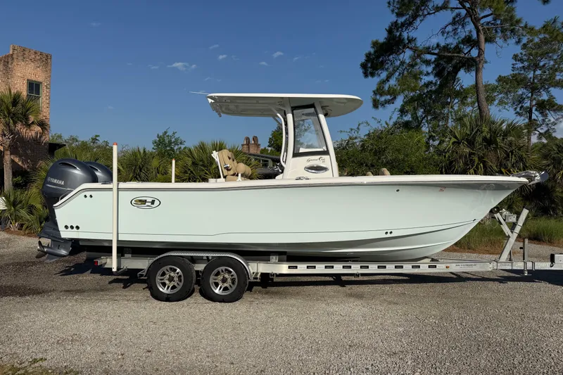 Slide: The Image of 2017 Sea Hunt Gamefish 25 boat on trailer, parked outdoors under clear sky. - 6