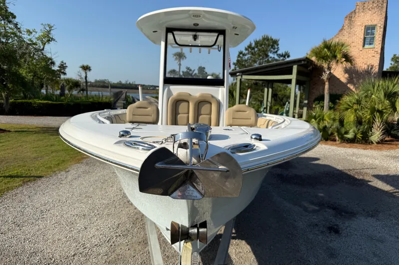 Slide: The Image of 2017 Sea Hunt Gamefish 25 boat with anchor, parked outdoors near palm trees. - 8