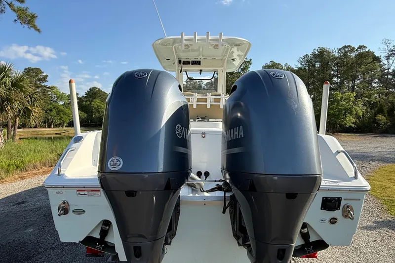 Slide: The Image of 2017 Sea Hunt Gamefish 25 boat with dual Yamaha engines, parked outdoors. - 9