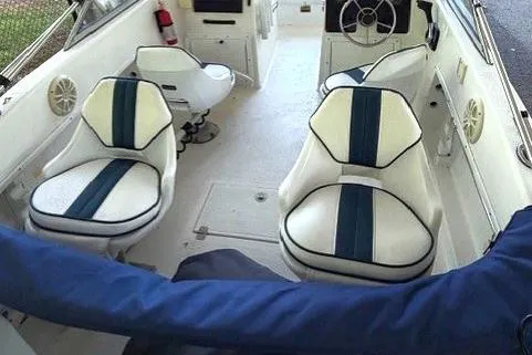 Slide: The Image of Interior of a 2001 Clearwater 2200 Dual Console boat with white and blue seating. - 4