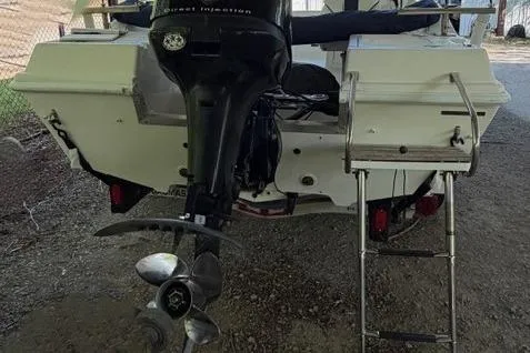 Slide: The Image of 2001 Clearwater 2200 Dual Console boat with outboard motor and ladder. - 5