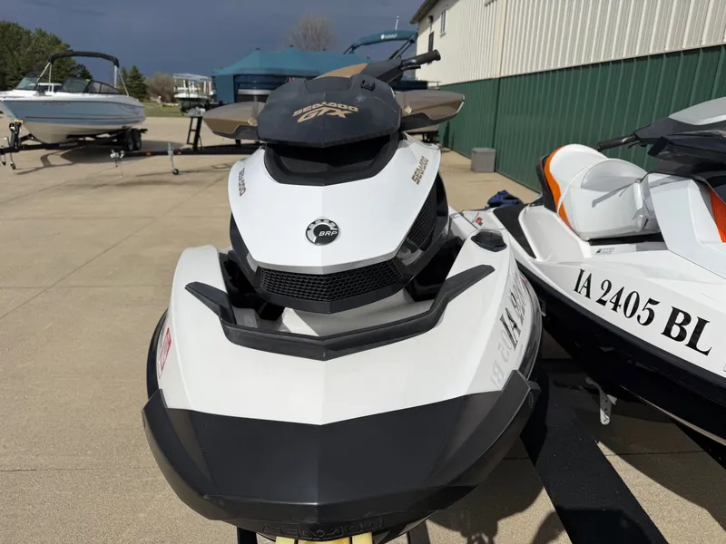 Slide: The Image of 2012 Sea-Doo GTX 155 jet ski parked outdoors. - 3