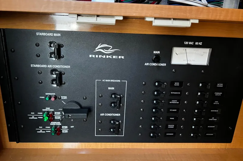 Slide: The Image of Control panel of a 2009 Rinker 340 Express Cruiser, featuring various switches and indicators. - 12