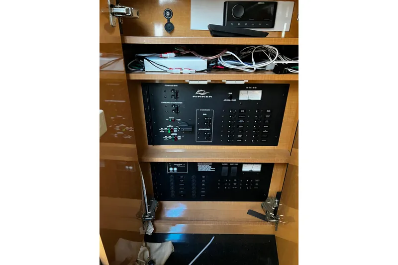 Slide: The Image of Electrical panel of a 2009 Rinker 340 Express Cruiser with wiring and controls. - 14