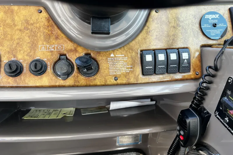 Slide: The Image of Control panel of a 2009 Rinker 340 Express Cruiser with switches and outlets. - 15