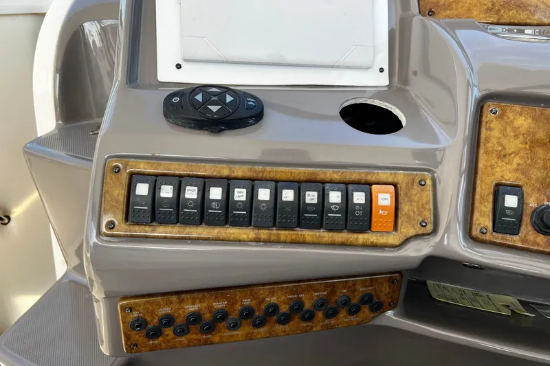 Slide: The Image of Control panel of a 2009 Rinker 340 Express Cruiser boat. - 16