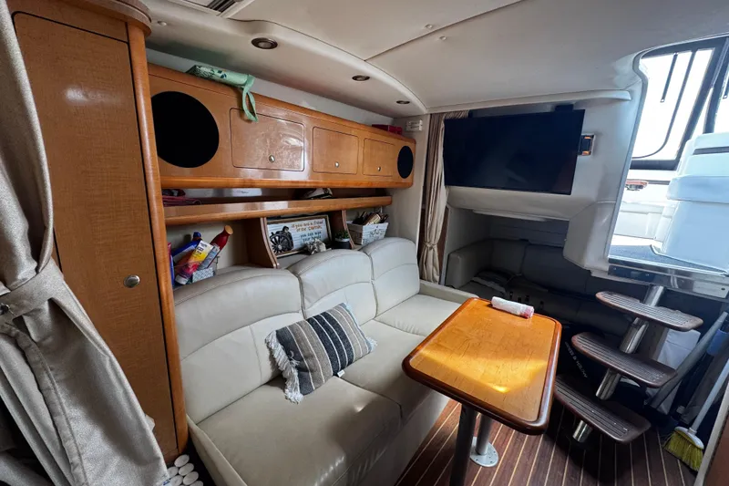 Slide: The Image of Interior of 2009 Rinker 340 Express Cruiser with cozy seating and wooden table. - 22