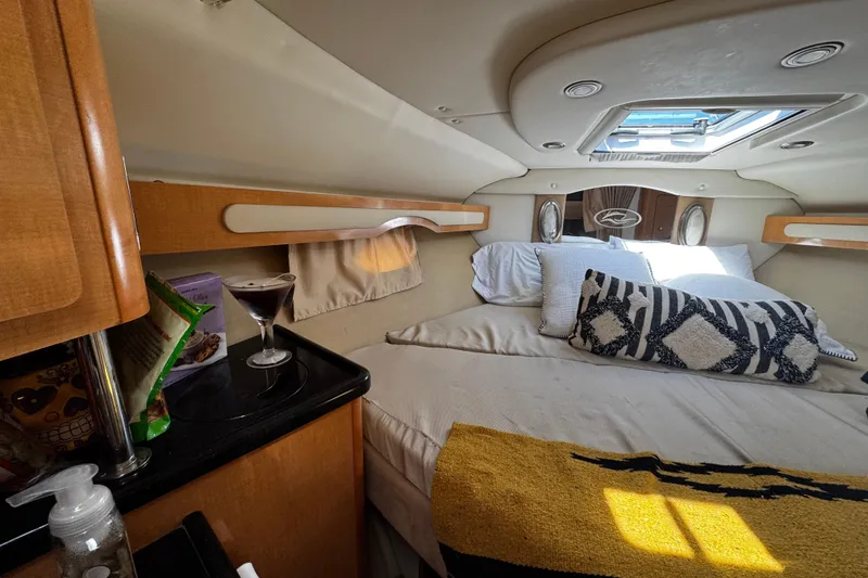 Slide: The Image of Interior of 2009 Rinker 340 Express Cruiser with cozy bed and stylish decor. - 24