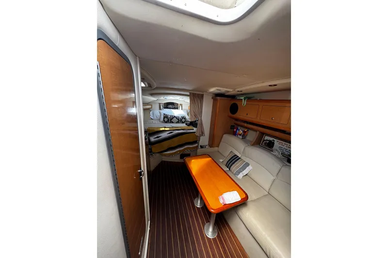 Slide: The Image of Interior of 2009 Rinker 340 Express Cruiser with cozy seating and wooden table. - 27