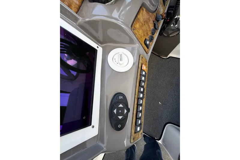 Slide: The Image of Control panel of a 2009 Rinker 340 Express Cruiser with navigation and control buttons. - 28