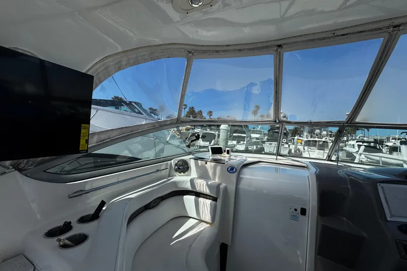 Slide: The Image of Interior view of 2009 Rinker 340 Express Cruiser with marina backdrop. - 33