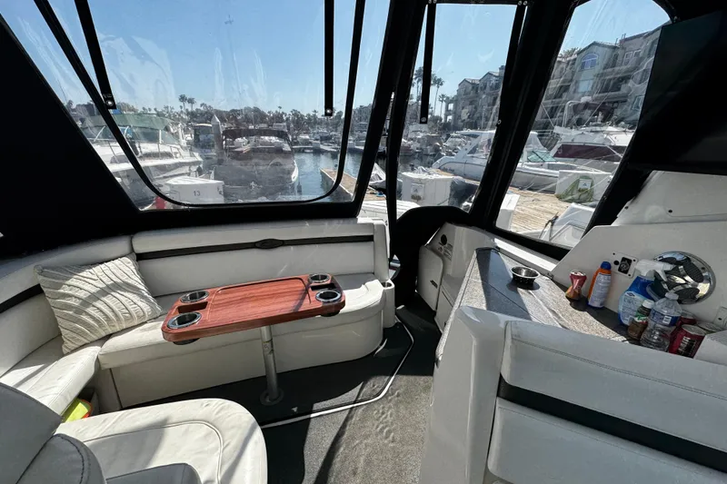 Slide: The Image of Interior of 2009 Rinker 340 Express Cruiser with marina view through windows. - 36
