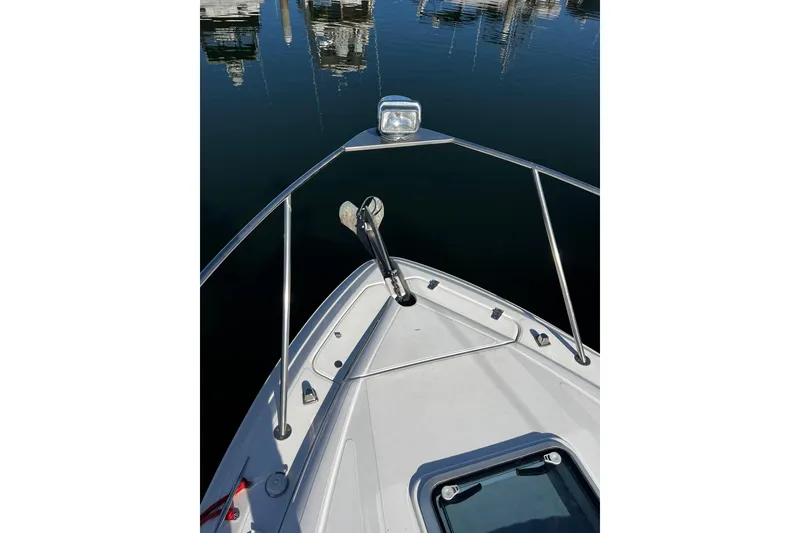 Slide: The Image of Bow view of 2009 Rinker 340 Express Cruiser with calm water reflections. - 7