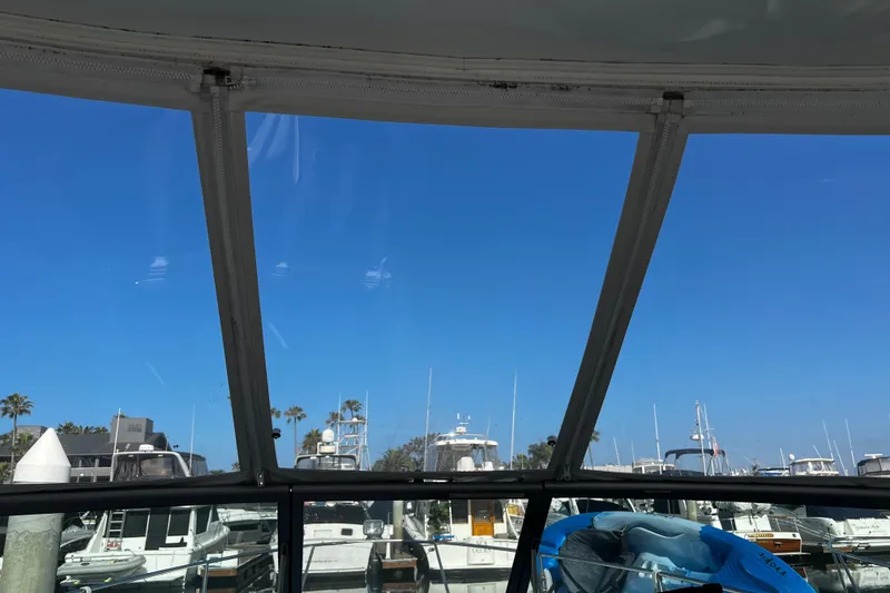 Slide: The Image of View from a 2009 Rinker 340 Express Cruiser, overlooking a marina under clear blue skies. - 8