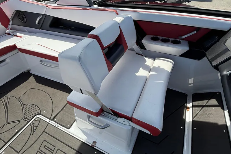Slide: The Image of 2022 Scarab 285 ID boat interior with white and red seating and cup holders. - 12