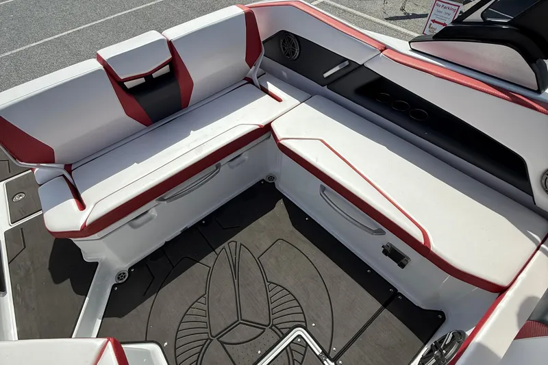 Slide: The Image of 2022 Scarab 285 ID boat interior with red and white seating and storage compartments. - 13