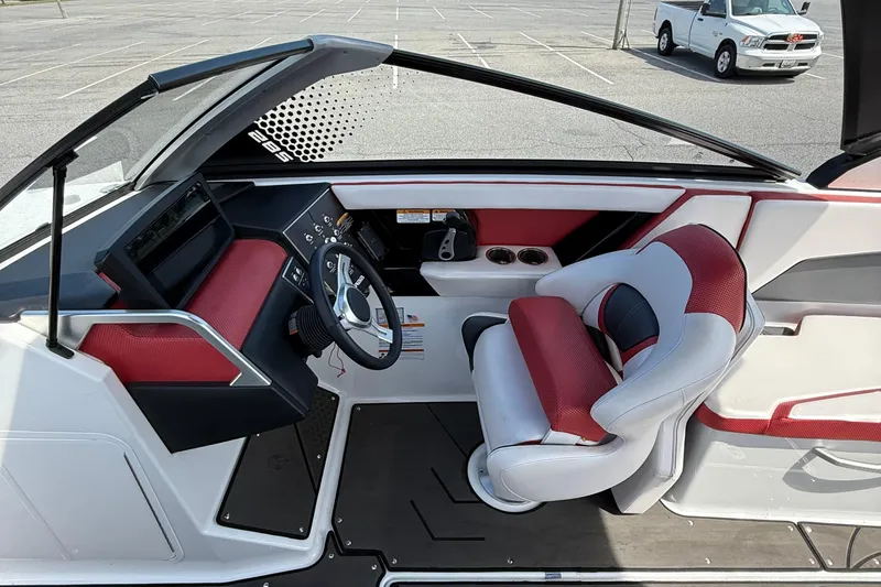 Slide: The Image of Interior of 2022 Scarab 285 ID boat with red and white seating and modern dashboard. - 14