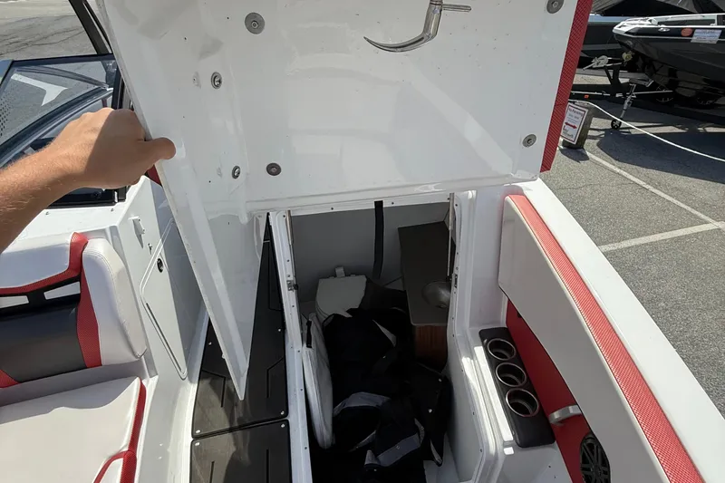 Slide: The Image of 2022 Scarab 285 ID boat interior storage compartment with seating and cup holders. - 16
