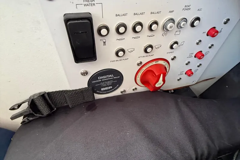 Slide: The Image of Control panel of a 2022 Scarab 285 ID boat with switches and digital relay. - 18