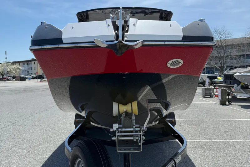 Slide: The Image of 2022 Scarab 285 ID boat on trailer, red and black hull, parked outdoors. - 3