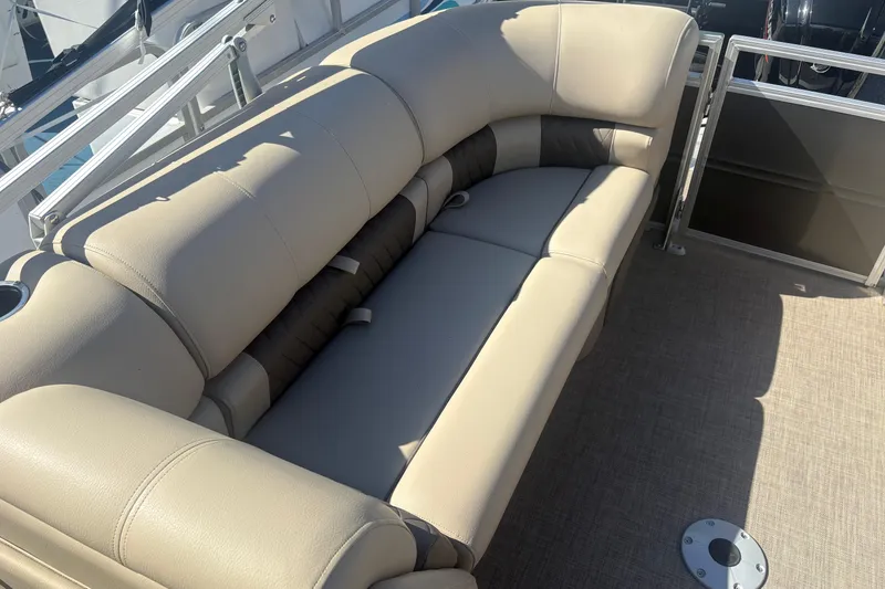 Slide: The Image of 2024 Sun Tracker Party Barge 22 DLX pontoon boat with beige seating and cup holders. - 11