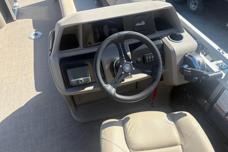 Slide: The Image of 2024 Sun Tracker Party Barge 22 DLX helm with steering wheel and controls. - 5