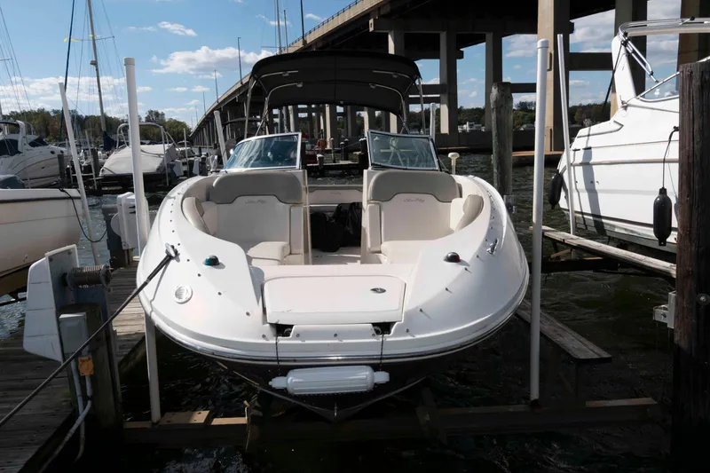 Slide: The Image of 2007 Sea Ray 260 Sundeck boat docked at marina under bridge. - 2