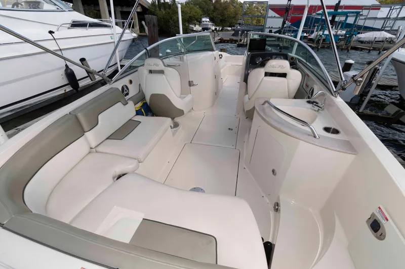 Slide: The Image of 2007 Sea Ray 260 Sundeck boat interior with seating and helm, docked at marina. - 3