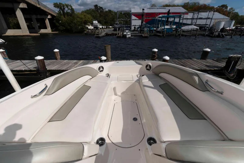 Slide: The Image of 2007 Sea Ray 260 Sundeck boat interior with spacious seating at a marina. - 5