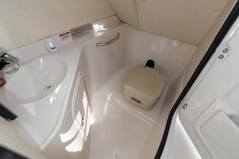 Slide: The Image of Interior of 2007 Sea Ray 260 Sundeck boat bathroom with sink and portable toilet. - 9