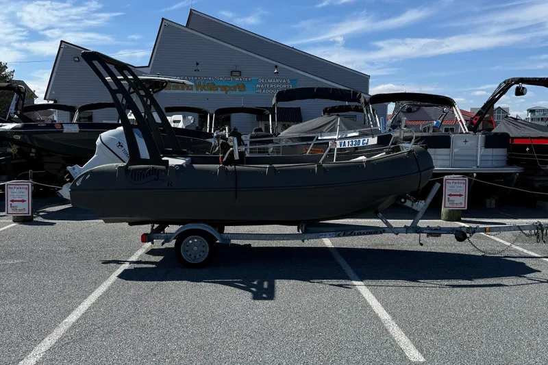 The Image of 2021 Whaly 445R boat on trailer in parking lot, surrounded by other boats. - 1