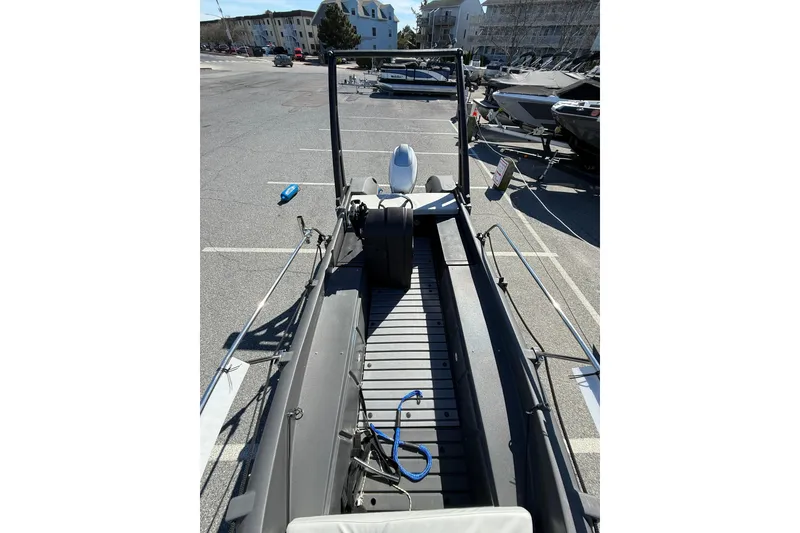 Slide: The Image of 2021 Whaly 445R boat parked in a marina lot, showcasing interior and seating. - 12