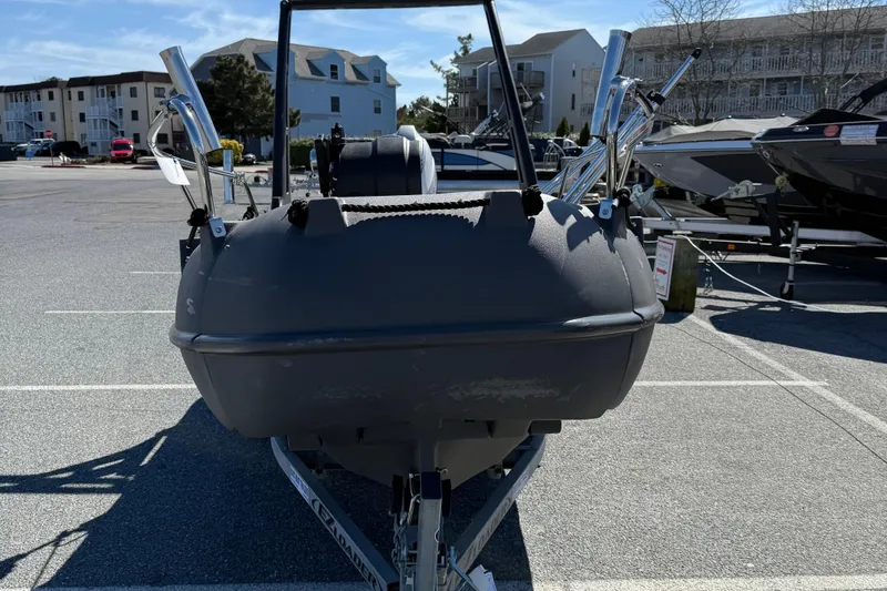 Slide: The Image of 2021 Whaly 445R boat on trailer in parking lot, surrounded by buildings and other boats. - 3