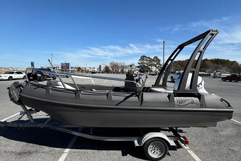 Slide: The Image of 2021 Whaly 445R boat on trailer in parking lot under clear blue sky. - 5