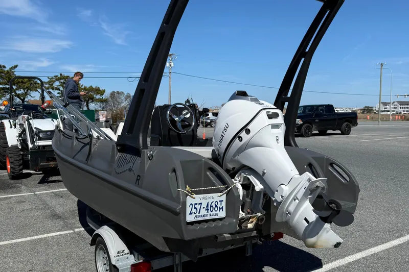 Slide: The Image of 2021 Whaly 445R boat with Tohatsu engine on trailer in parking lot. - 6