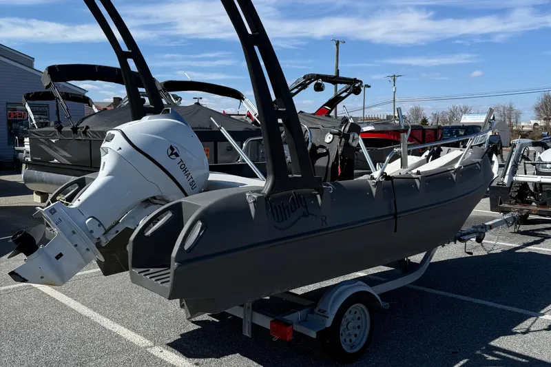 Slide: The Image of 2021 Whaly 445R boat with Tohatsu engine on trailer, parked outdoors. - 8