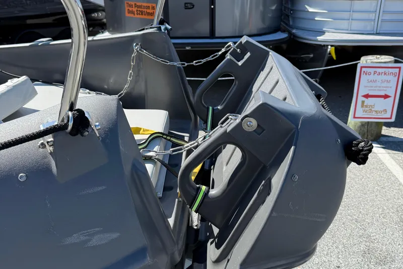 Slide: The Image of 2021 Whaly 445R boat with sturdy handles and ropes, parked near a "No Parking" sign. - 9