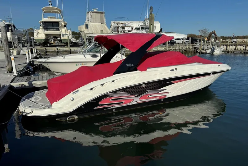The Image of 2012 Chaparral 2870 SSX boat with red cover docked at marina. - 0
