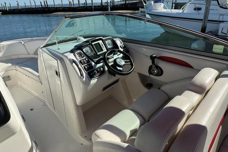 Slide: The Image of 2012 Chaparral 2870 SSX boat interior with steering wheel and dashboard at marina. - 6
