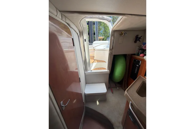 Slide: The Image of Interior view of 2003 Wellcraft 2600 Martinique boat, featuring cabin entrance and compact amenities. - 10