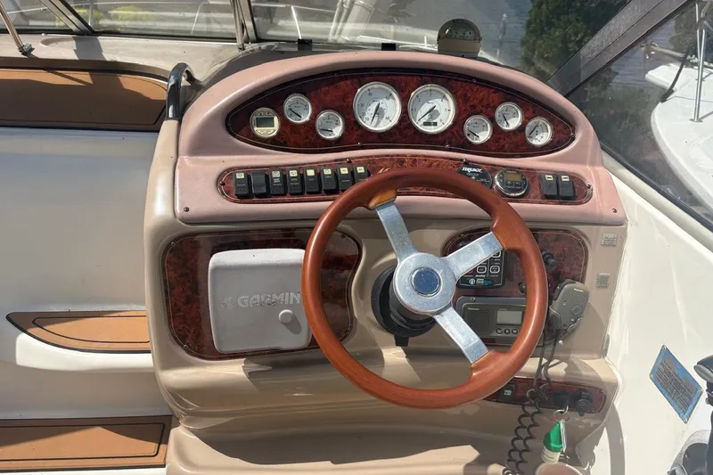 Slide: The Image of Dashboard of a 2003 Wellcraft 2600 Martinique boat with gauges and controls. - 12