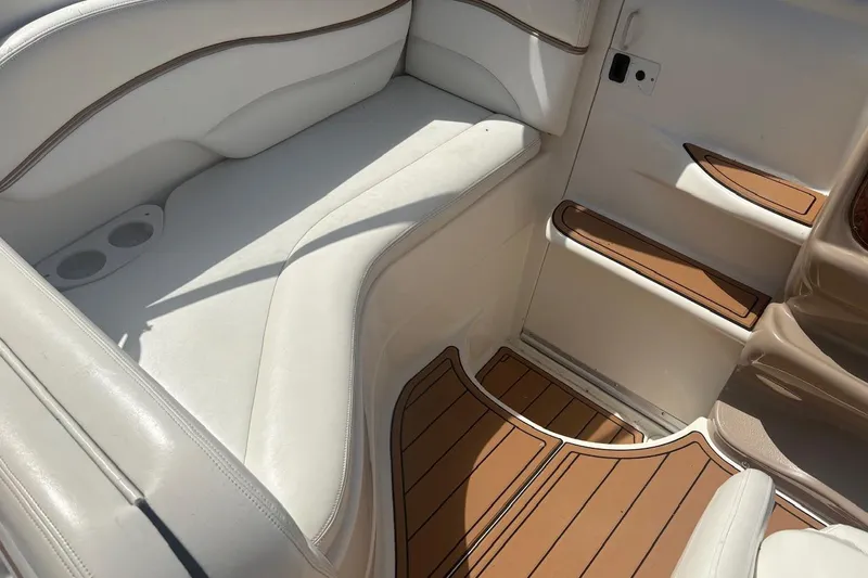 Slide: The Image of 2003 Wellcraft 2600 Martinique interior with white seating and wood-style flooring. - 15