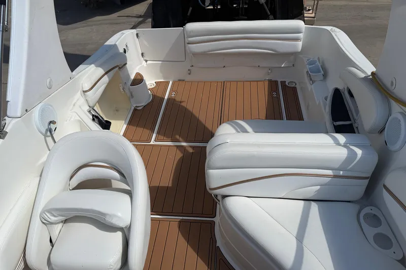Slide: The Image of 2003 Wellcraft 2600 Martinique boat interior with white seating and wood-style flooring. - 4