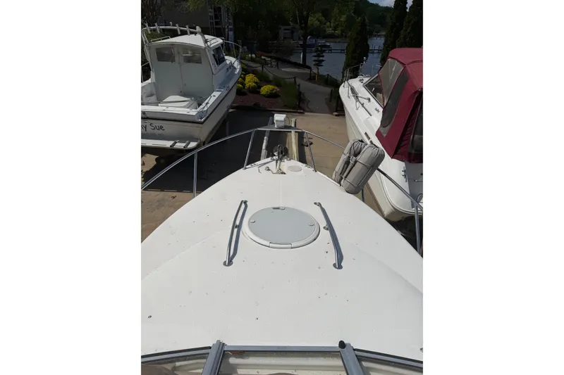 Slide: The Image of 2003 Wellcraft 2600 Martinique boat docked, surrounded by other boats, sunny day. - 5