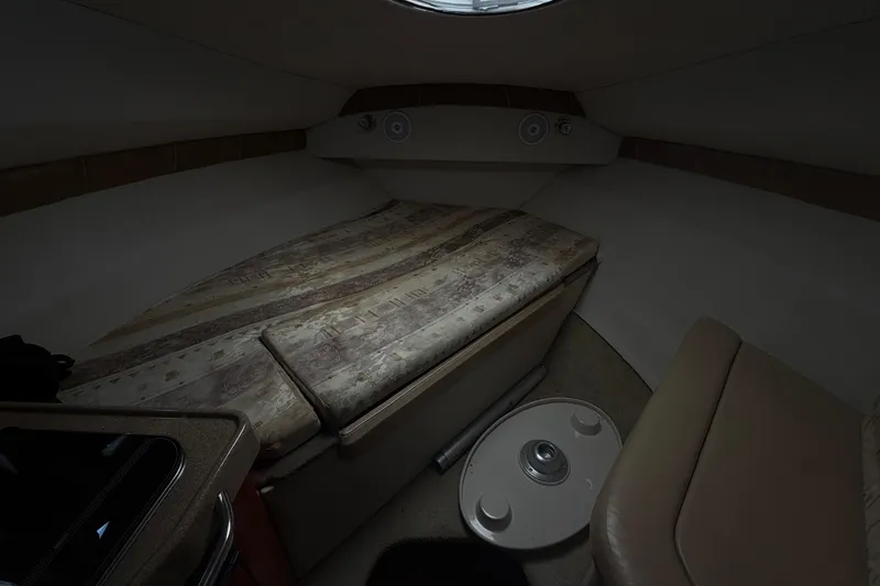 Slide: The Image of 2003 Wellcraft 2600 Martinique cabin interior with bed and seating area. - 8