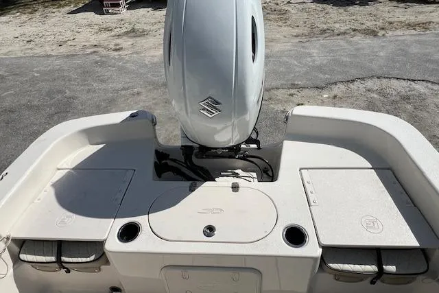 Slide: The Image of 2022 Carolina Skiff 21 LS boat with Suzuki outboard motor, rear deck view. - 2