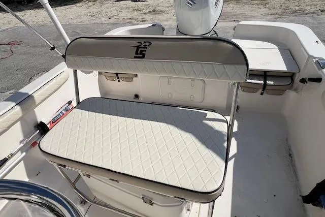 Slide: The Image of 2022 Carolina Skiff 21 LS boat interior with cushioned seating and storage compartments. - 3